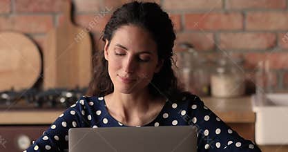 Woman sit indoor working on laptop search of inspiration