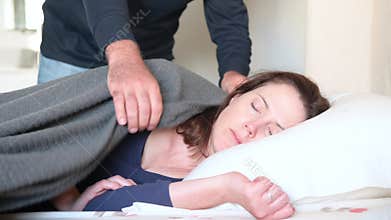 Woman pretending to sleep afraid from violent husband