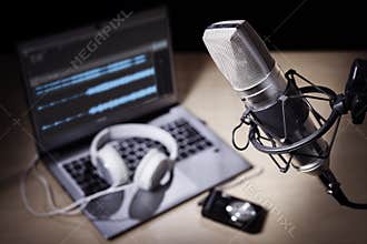 Podcast microphone and laptop computer in recording studio