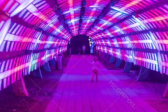 Dubai,UAE - 05.11.2021 Kids playing in the light tunnel installation at Dubai garden glow. Outdoors