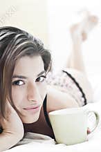Young woman and the cup of coffee