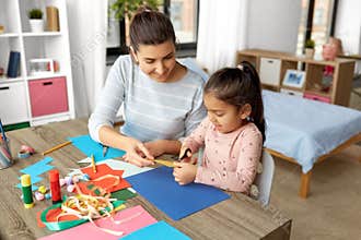 daughter with mother making applique at home