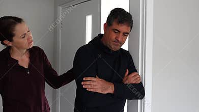 Woman comforting sad man looking down upset