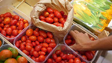 Girl goes shopping at the vegetable market.