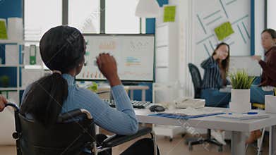 Man employee helping his invalid african colleague coming in workplace