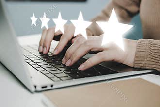5 star rating. business woman hand working on laptop with five star button on visual screen to review good rating, digital marketi