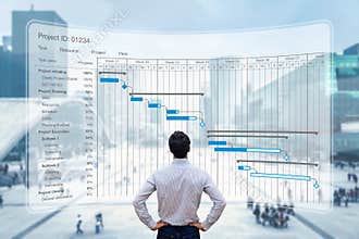 Project manager working with Gantt chart planning schedule, tracking milestones and deliverables and updating tasks progress,