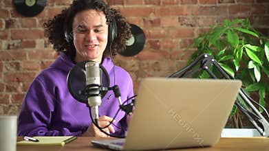 Man host telling news at microphone and having fun during radio broadcast in studio spbd.