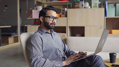 Indian business man trader investor analyst looking at financial market charts.
