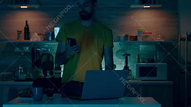 Man sitting in kitchen switch off the lights using voice command