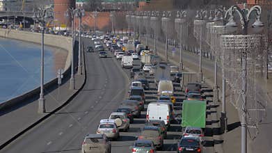 traffic jam in Moscow in winter, cars are moving along Kremlin on river embankment