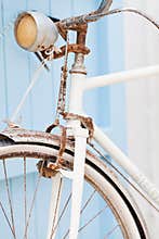 Old bicycle leaning against blue door.