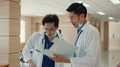 Asian doctors talk and discuss about patient`s case in hospital. Asia men medical practitioner consult patient case,