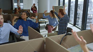 Business team celebrating new project in office. Managers giving high five