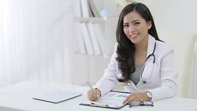portrait of female doctor on her desk