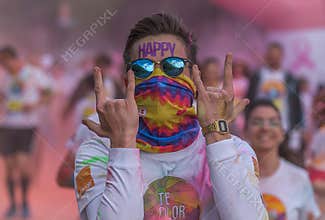 Happy young man running again after restriction to the new event of Colors Run Romania.