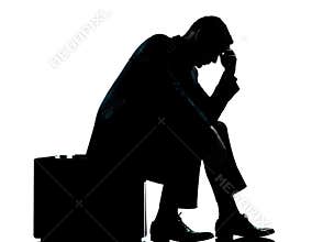 One business man sitting on suitcase silhouette