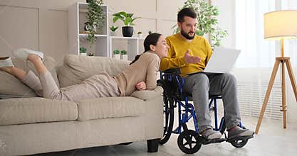 Couple discussing work on laptop at home