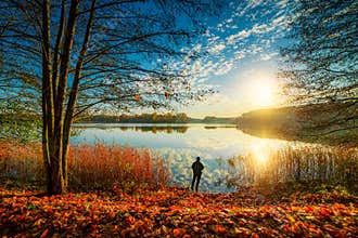 man fishing in fall sunrise
