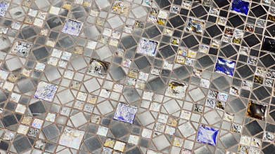 Abstract video of beautiful multi-colored mosaic as a floor covering, reflection of light on a glossy coating, elements