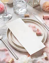 Wedding Table place with a card near pink flowers, feathers and silk ribbons, menu mockup