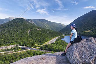 Chinese woman in deep thought atop mountain summit
