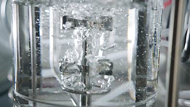 Slow motion shot of a mixer used in a chemistry lab to mix liquids