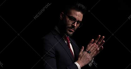 Young elegant businessman on black dark background