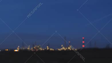 Blurry industrial night lights from moving car background