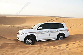 White SUV Toyota Land Cruiser in desert