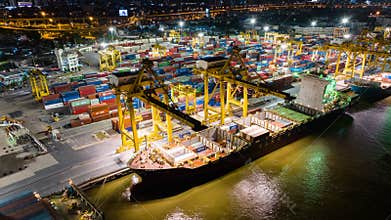 Hyperlapse time-lapse of shipping port with cargo container ship, crane, in Asia city at night