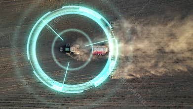 5G autonomous tractor without a driver working the soil before sowing. Future technology with smart agriculture farming