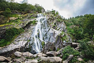 Beautiful water cascade of Powerscourt Waterfall, the highest waterfall in Ireland. Famous tourist atractions in co