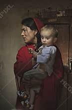 Muslim Ismaili i mother and son inside house in Shimshal village.