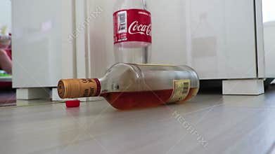 Rolling alcohol bottle in apartment Hangover Bangkok Thailand Asia