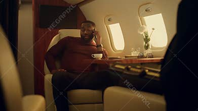 Plane passenger talking cellphone on vacation trip. Confident businessman work