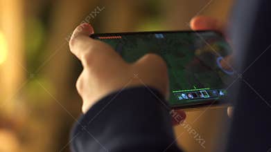 the guy plays minecraft on the phone. Kid use mobile as playing device
