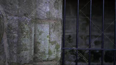 Metal bars outside stone archway of old stone dungeon