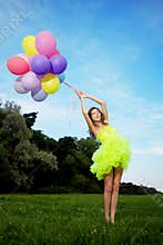 Woman holding bunch of colorful air balloons