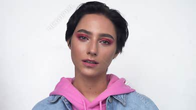 Cool gen z teen girl looking at camera on blue background. Portrait