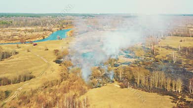 Aerial View. Spring Dry Grass Burns During Drought Hot Weather. Bush Fire And Smoke In Meadow Field. Wild Open Fire
