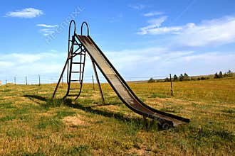 Old slippery-slide remains in a rural playground setting