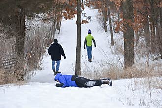 Boy Rolling down Snow Hill
