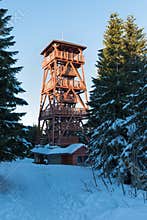 A new beautiful wooden lookout tower at the top of the VrchmezÃ­ peak. Winter landscape near Zieleniec ski arena, Eagle mountains