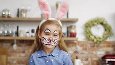 Portrait video of cute playful girl dressed as easter bunny.