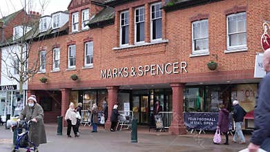 People And Shoppers Walking Past A High Street Branch Of A Marks And Spencer Department Store