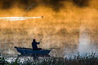 Fishing in a misty morning  man's hobby