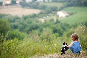 Adorable girl and a cat outdoors