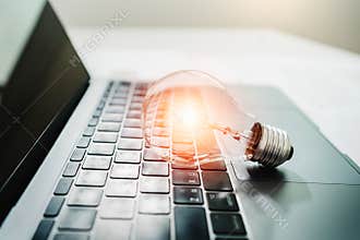 light bulb on laptop computer. power energy concept