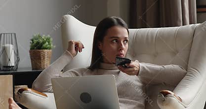 Young woman holding smartphone send voice message to friend